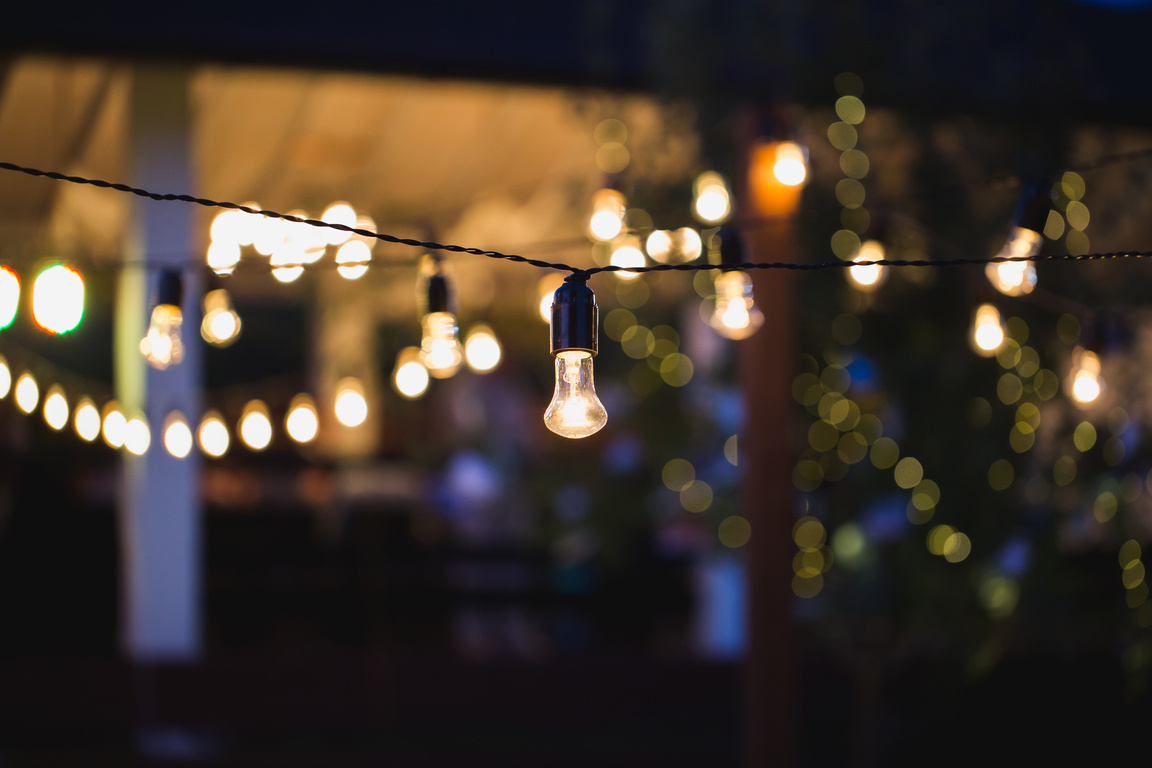 Outdoor String Lights Hanging on a Line in Backyard.